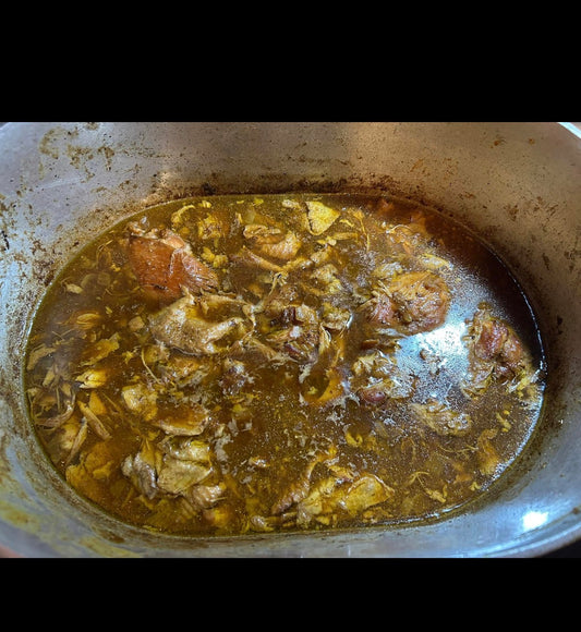Smothered sticky chicken thighs in dark gravy served over white rice