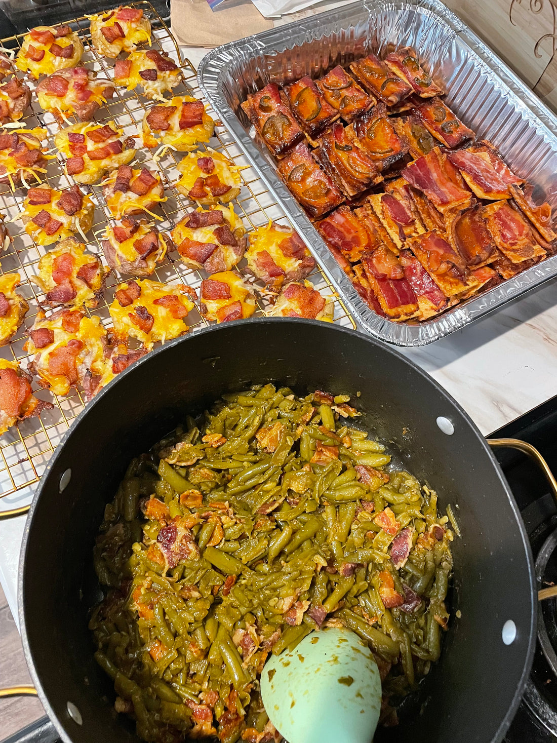 Club crackers topped with caramelized bacon and candied jalapeños on a baking rack