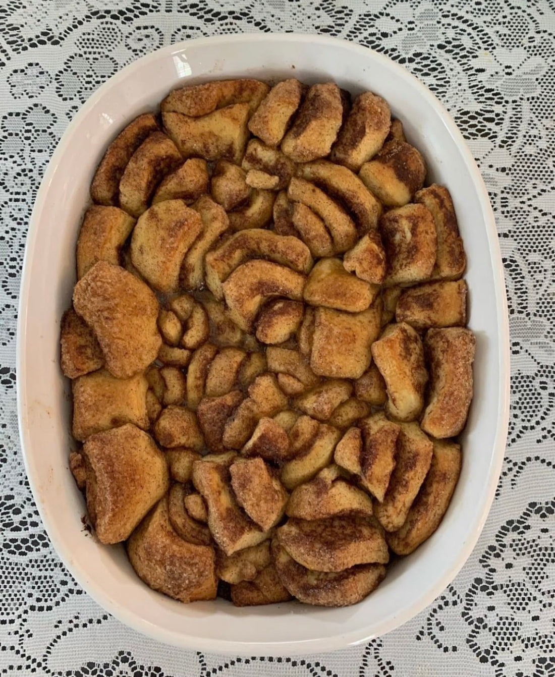 Cinnamon roll monkey bread turned out of a loaf pan, golden and caramelized