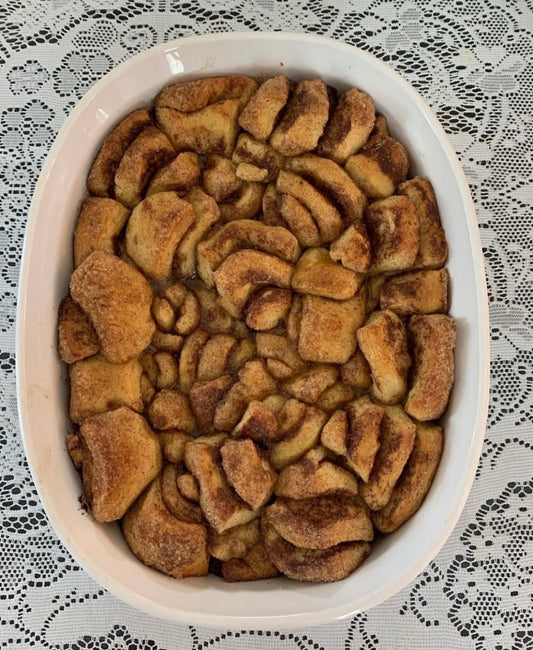 Cinnamon roll monkey bread turned out of a loaf pan, golden and caramelized
