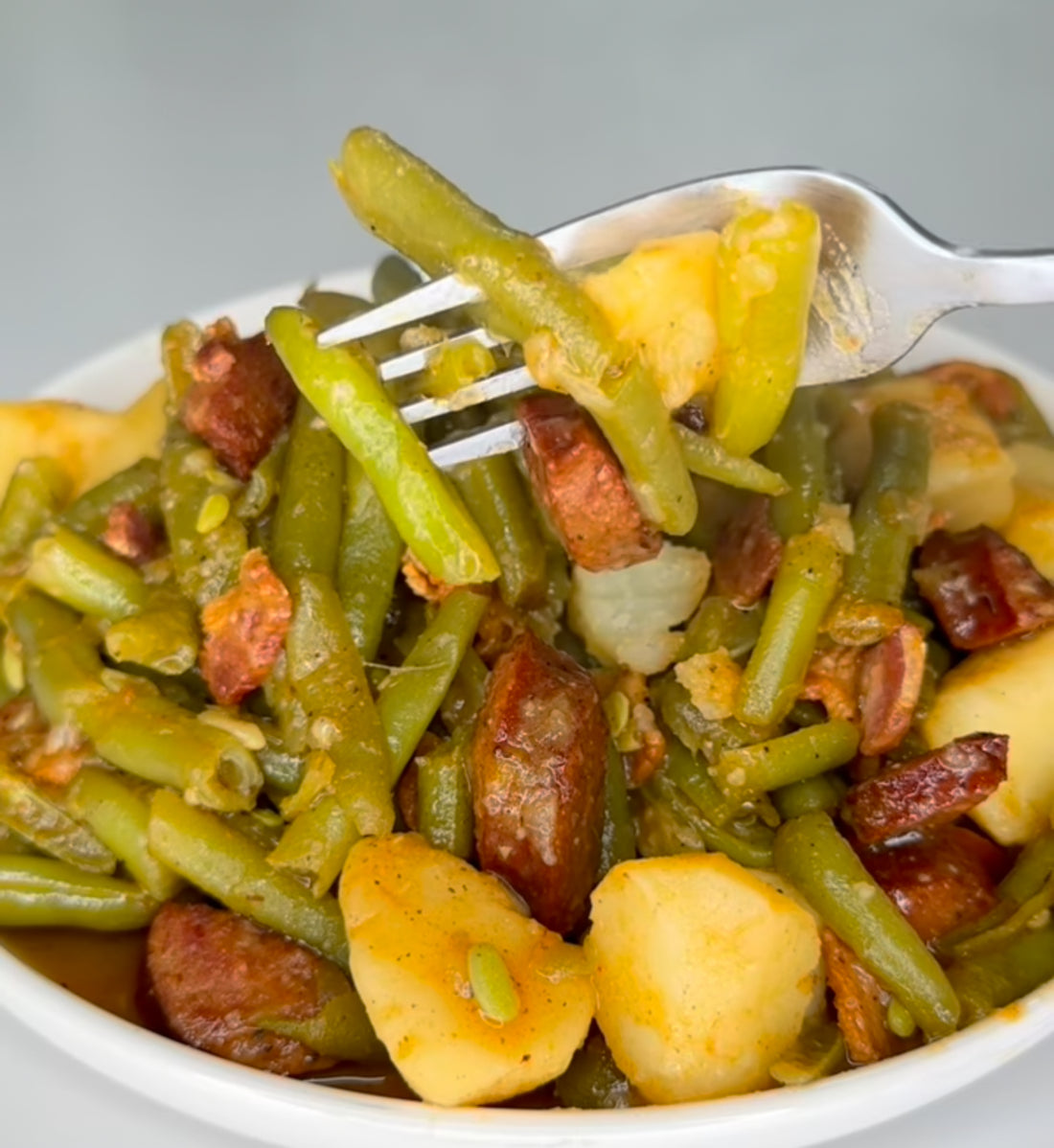Smothered green beans with smoked sausage, bacon, and red potatoes, member submitted recipe by Katie Rice, Foodies of Lafayette