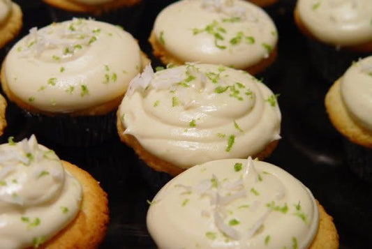 Coconut and key lime cupcakes topped with cream cheese frosting, lime zest and toasted coconut