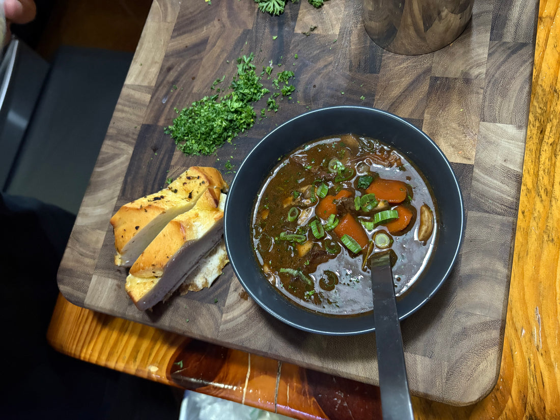 A Dutch oven of beef bourguignon with carrots, mushrooms and pearl onions in red wine sauce