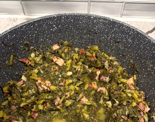 A pot of southern-style greens simmered with tasso