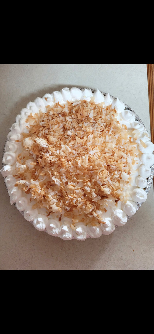 Coconut cream pie topped with whipped cream and toasted coconut